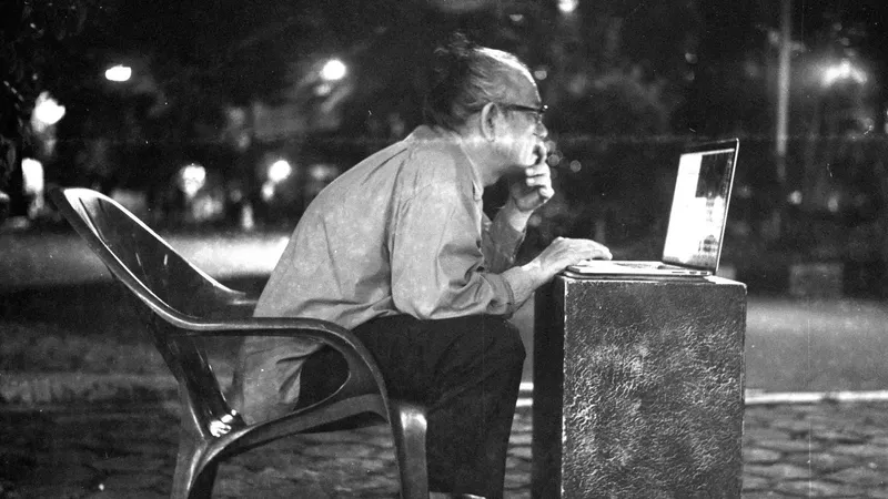 Man working on a laptop alone late at night