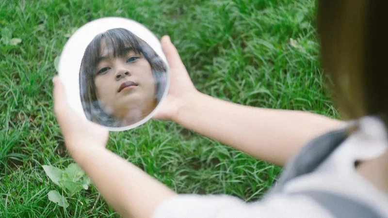 A person looking in a mirror and seeing a distorted, unqualified version of themselves, representing impostor syndrome.