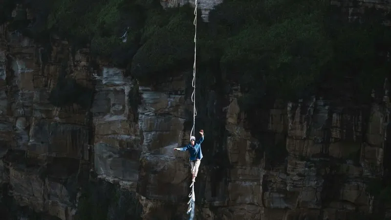 Person walking a tightrope over a canyon