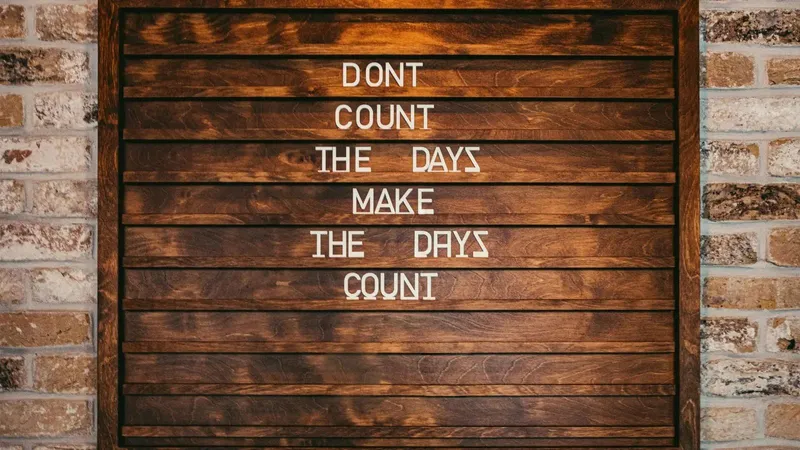 Don't count the days, make the days count written on a wooden board