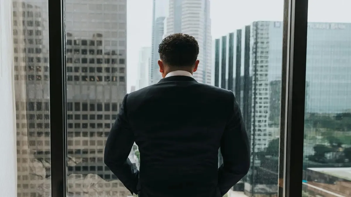 Corporate professional looking out the window