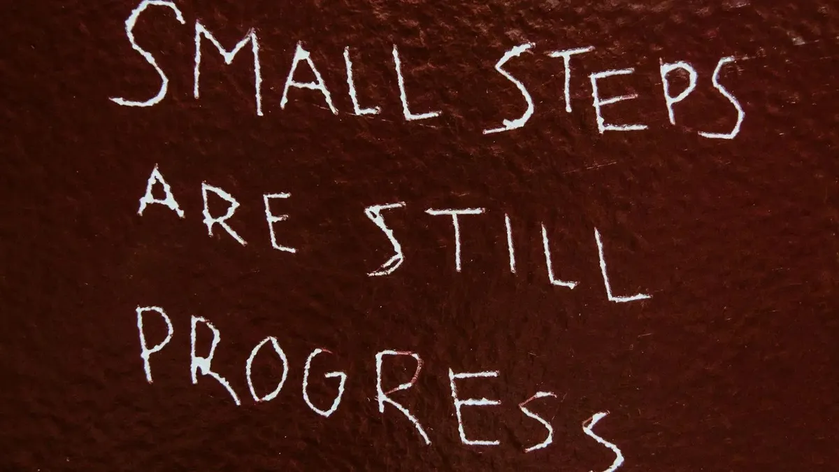 Small Steps Are Still Progress etched into a wall